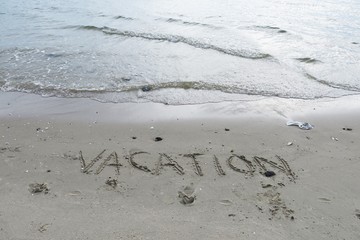 Writing on sand. Words on sand. Summer word on sand beach. Sandy beach background