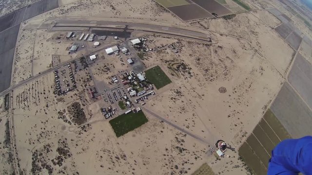 Professional parachute jumper parachuting above arizona. Scenery. Height. Extreme sport