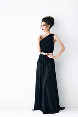 Fototapeta premium Beautiful young girl in a black dress