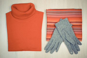 Vintage photo, Womanly clothes on wooden background, clothing for autumn or winter