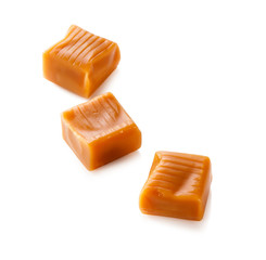 three toffee caramel candies close-up isolated on white background (with clipping path)

