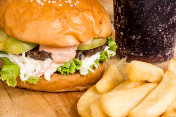 Hamburgers and French fries on the wood.