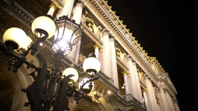 Antique street light near illuminated historic building, architecture and art