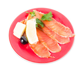 Sliced salmon with lemon and butter.