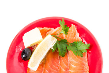 Sliced salmon with lemon and butter.