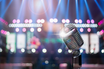 Fototapeta na wymiar Retro microphone over the Stage Spotlight with blue luminous ray