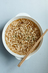 boil instant noddles with eggs on the white table