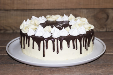 Round homemade cake with a meringue and chocolate