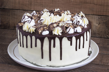 Round homemade cake with a meringue and chocolate