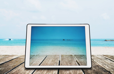 Digital Tablet on Wooden Desk at the Tropical Beach 