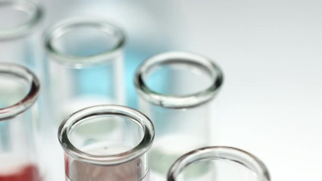 macro shot of pouring clean transparent liquid in test tube, water treatment experiment