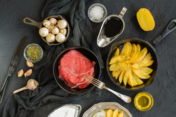 Healthy dinner ingredients over black stone table
