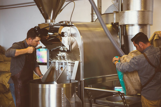 Two men working at coffee roasting factory