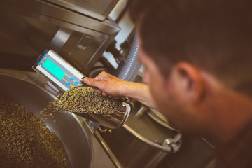 Worker filling machine with coffee beans