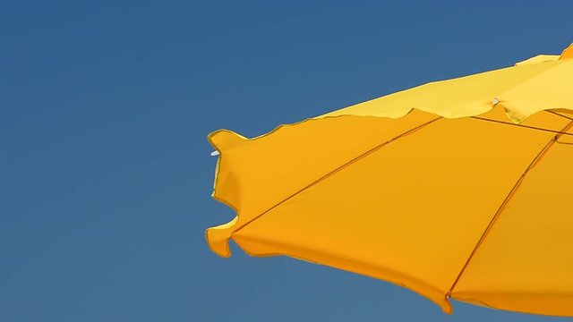 The umbrella on the beach and the wind