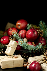 Fototapeta na wymiar Christmas and New year. Apples with pine cones and nuts in a bas