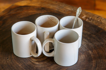four coffee cups in wooden table