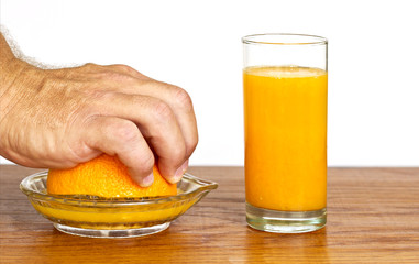 Man's hand squeezing an orange