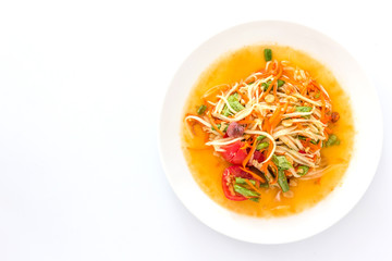 Spicy green papaya salad or somtum isolated on white background with copy space for text, Thai cuisine © navintar