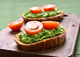 Sandwiches with pesto sauce and tomatoes