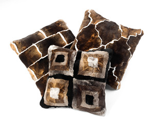 Three brown toned fur pillows