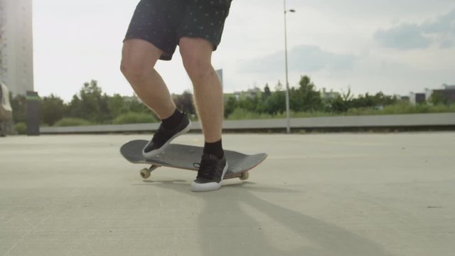 SLOW MOTION CLOSE UP: Skateboarder jumping tricks and falling on a street