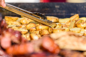 Preparing Grilled Potatoes On Barbecue