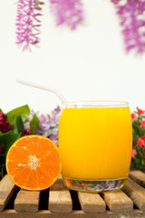 orange juice in glass and orange slice on wood table,drinking orange juice for healthy concept.