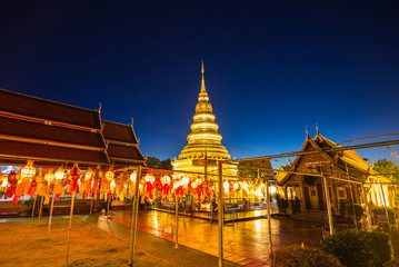 Fototapeta premium Festival lanterns hanging colorful night dark inside Wat Phra Haripunchai. Lamphun Thailand background