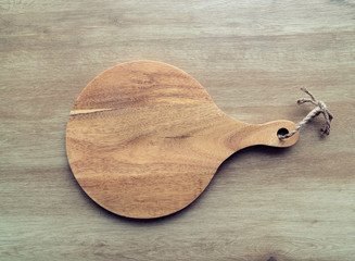 Empty round cutting board on wooden