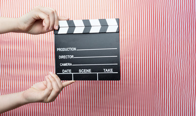 movie marker or clapper board set against a colorfull background