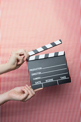 movie marker or clapper board set against a colorfull background