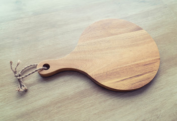 Empty round cutting board on wooden