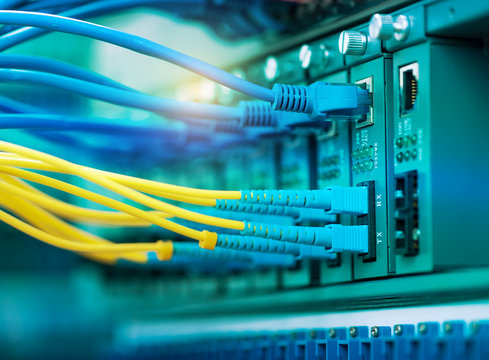 Fiber Optic cables connected to an optic ports and Network cable