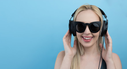 Young woman with headphones  listening to music and having fun a