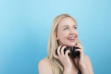 Young woman with headphones  listening to music and having fun a