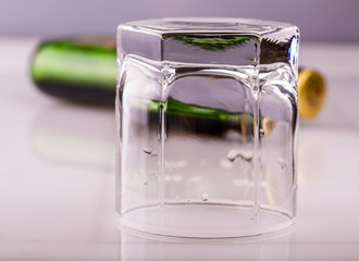 empy Glass without whiskey and empty bottle on the bar