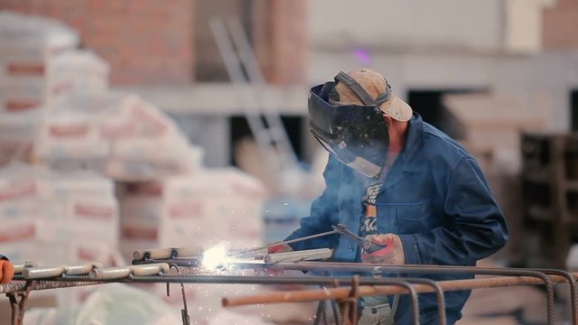 The builder welding the pipe to the construction