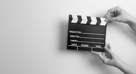 movie marker or clapper board set against a colorfull background
