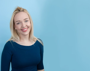 Fototapeta premium beautiful blond woman against blue background