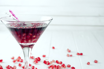 Pomegranate martini with pomegranate seeds in a glass