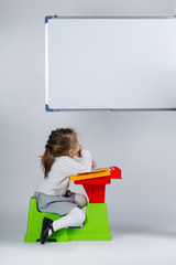 little girl looking at marker board