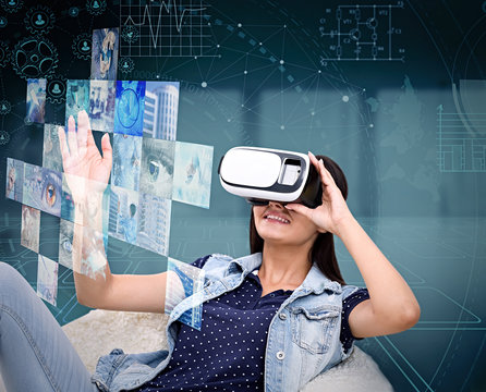 Young woman in virtual reality glasses. Projection of multimedia images. Future technology concept.