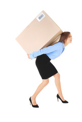Beautiful businesswoman carrying heavy box on white background