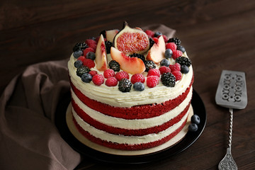 Tasty cake with berries on wooden background