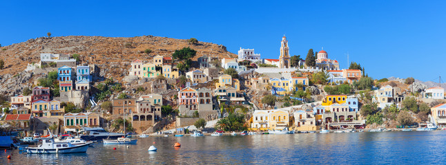 Symi island - Colorful houses and small boats at the heart of the village