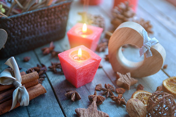 Fototapeta na wymiar Composition of candles and natural decor on wooden background, close up view