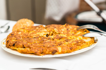A just cooked Spanish omelette served in a dish over the table