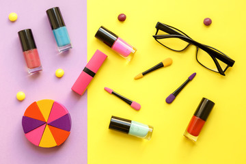 make up set on yellow and purple background top view