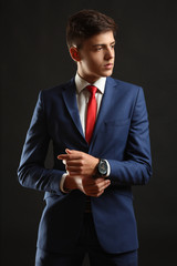 Young man posing in classic blue suit.